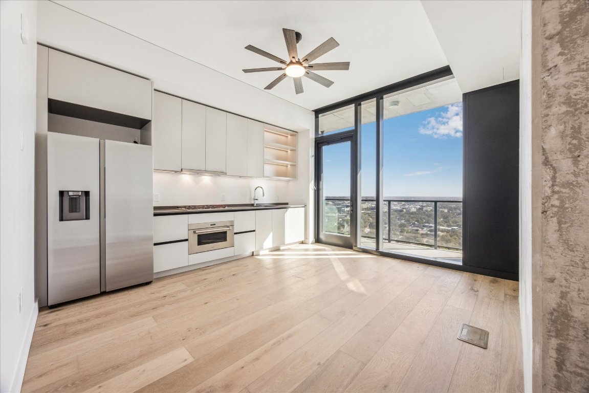 610 Davis Street, Unit 2201 Austin, TX 78701 - Photo 1 of 26 Kitchen/ living area featuring wide-plank oak flooring, quartzite countertops, contemporary Italkraft cabinetry, and top-tier Wolf and Bosch appliances