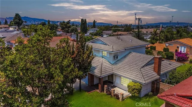 a aerial view of a house with a yard and potted plants