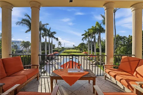 a view of a patio with a table chairs and a backyard