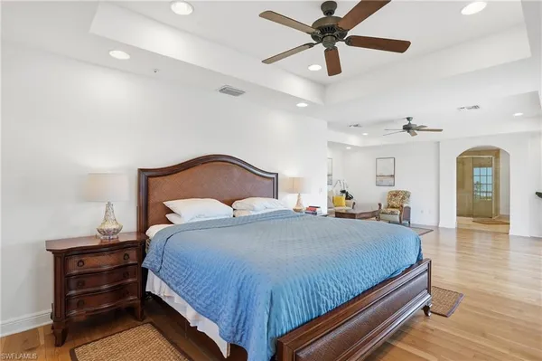 a view of a swimming pool with a table and chairs under an umbrella