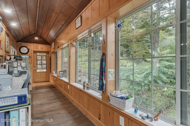 a view of an entryway with wooden floor and door