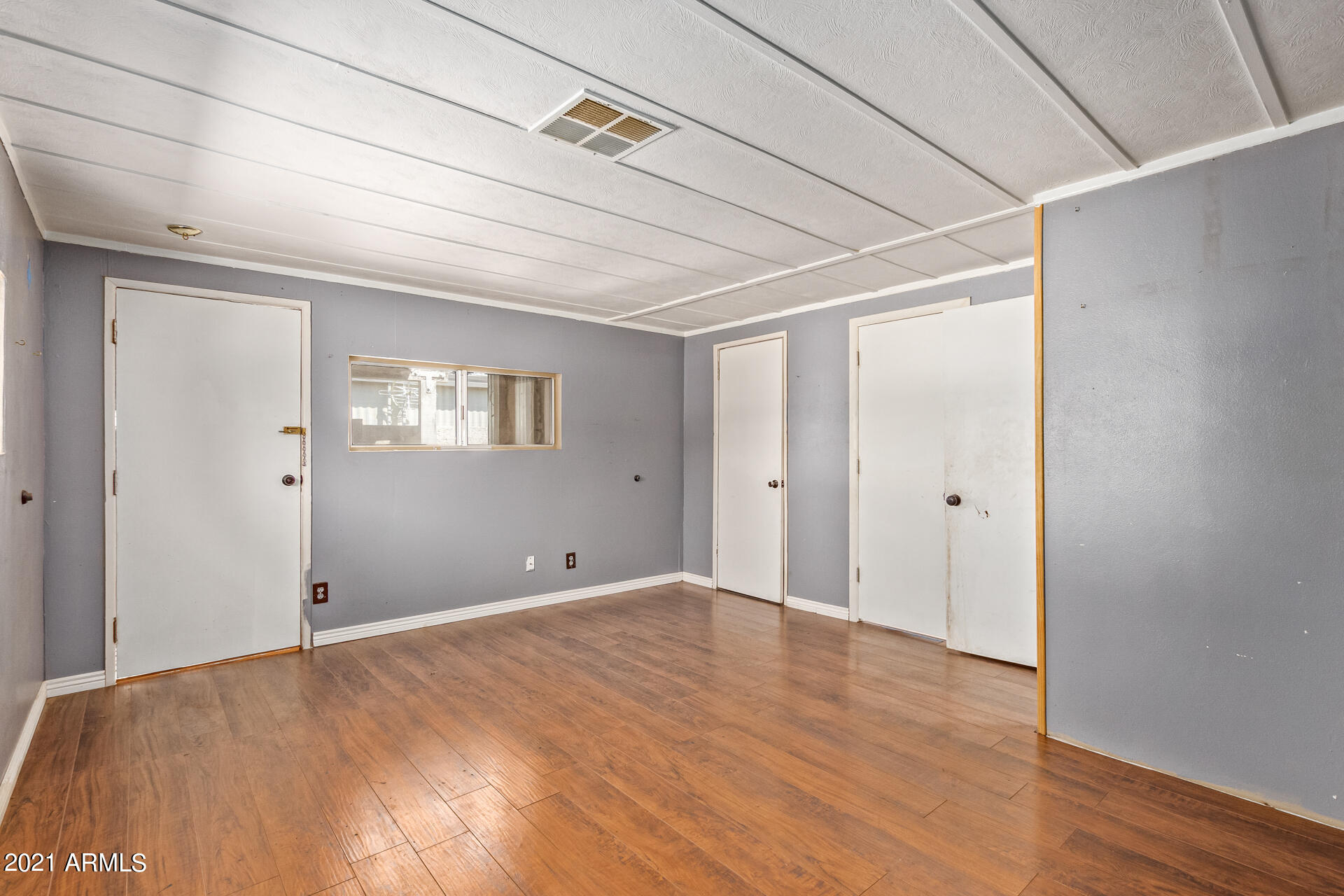 18835 North 25th Way Phoenix, AZ 85050 - Photo 11 of 24 a view of empty room with wooden floor