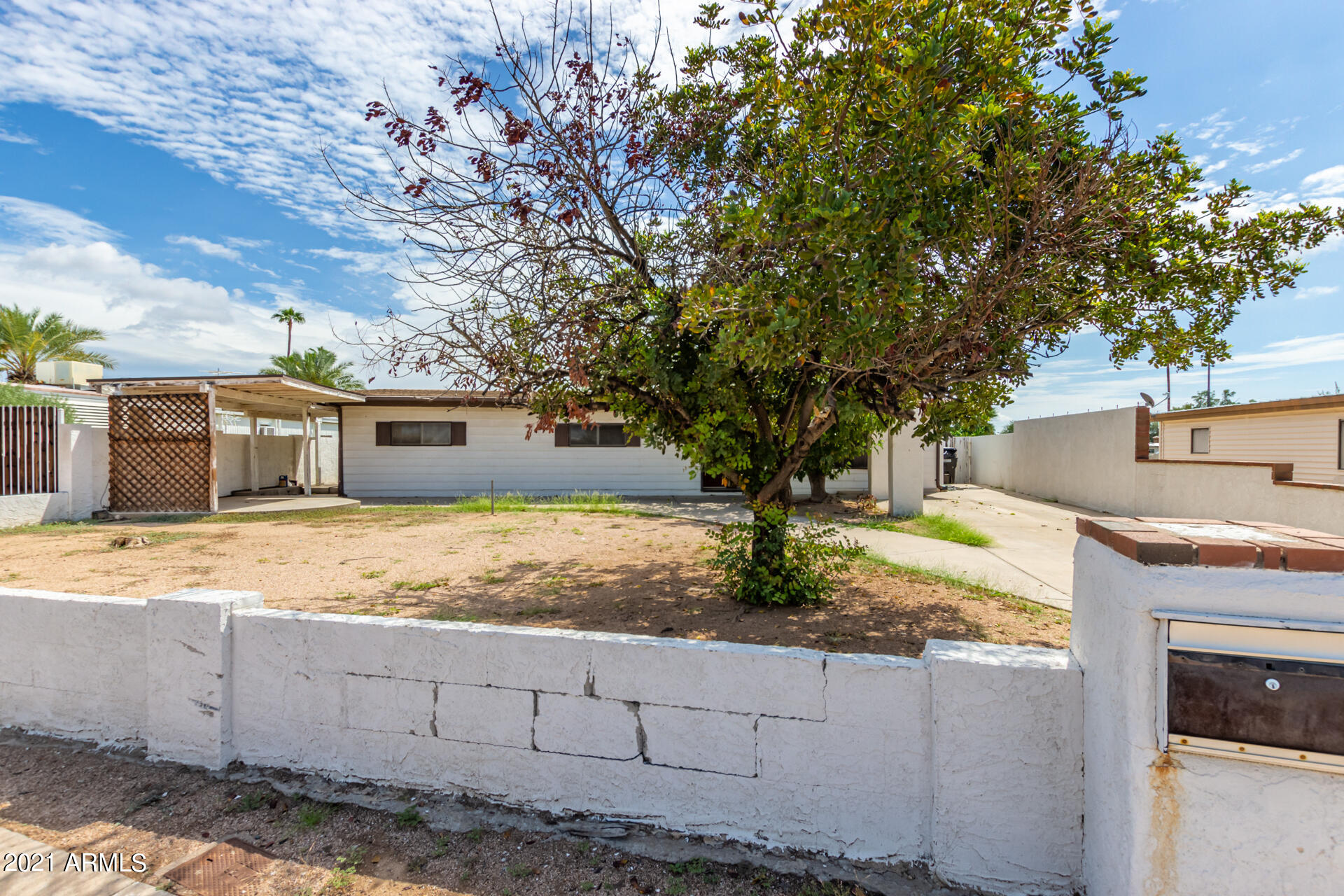18835 North 25th Way Phoenix, AZ 85050 - Photo 2 of 24 a white house that has tree in front of it