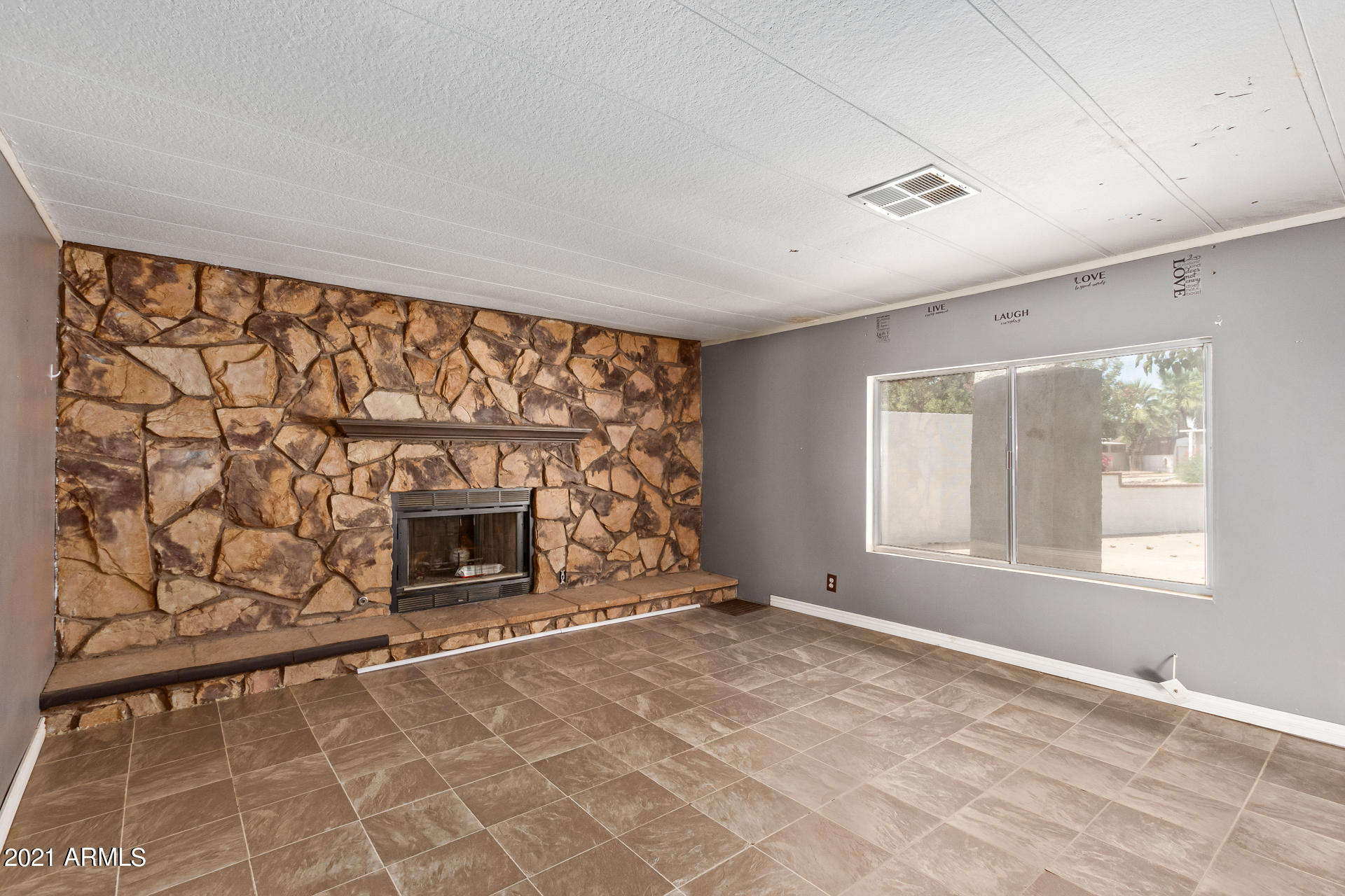 18835 North 25th Way Phoenix, AZ 85050 - Photo 6 of 24 a view of an empty room with a fireplace and a window