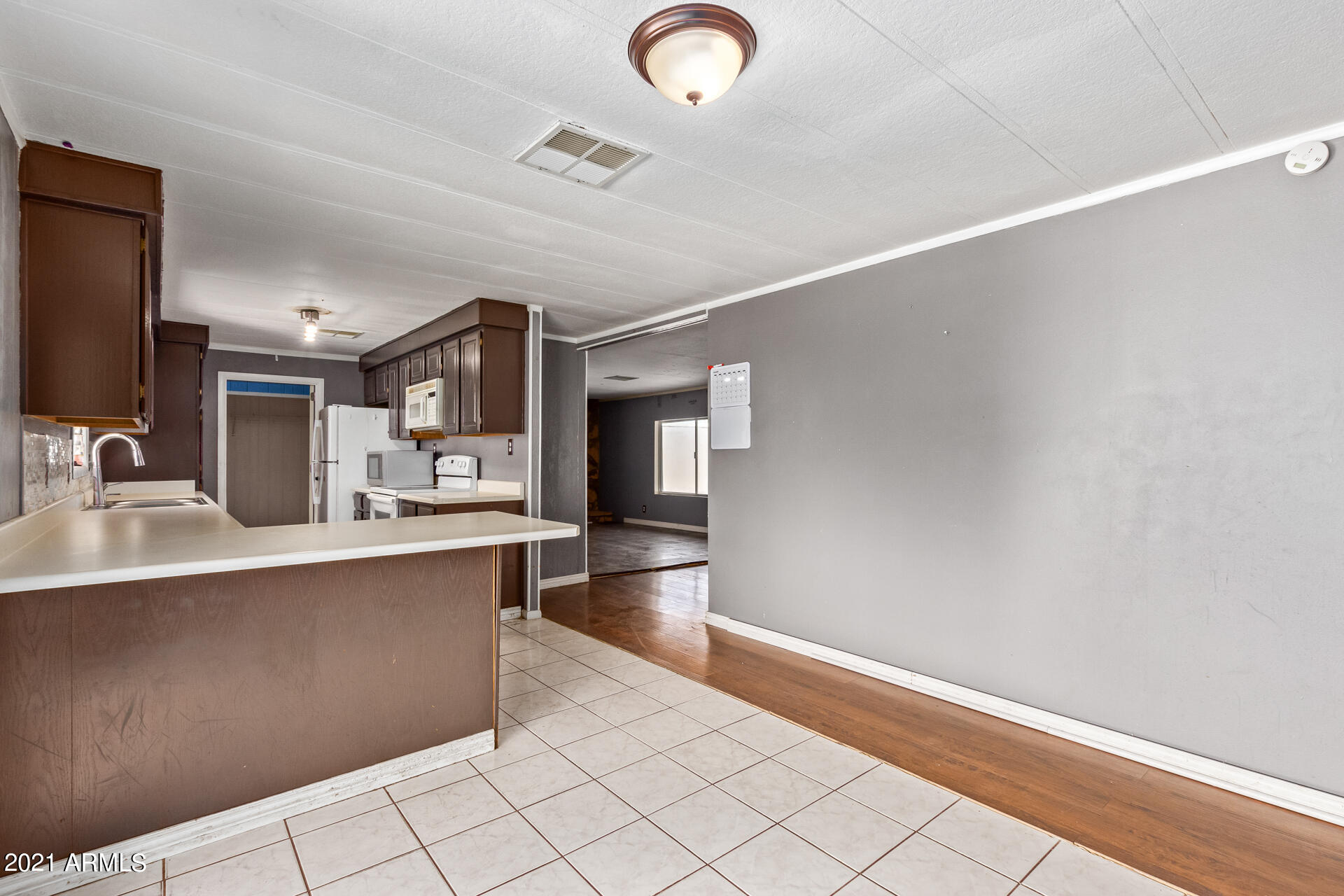 18835 North 25th Way Phoenix, AZ 85050 - Photo 9 of 24 a large kitchen with kitchen island a sink stainless steel appliances and cabinets