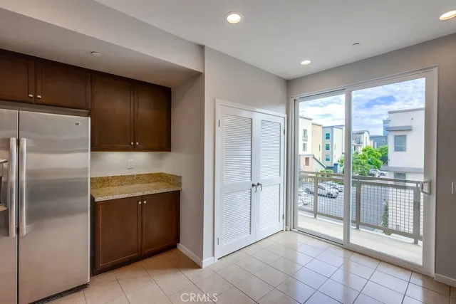 a kitchen with stainless steel appliances granite countertop a refrigerator and a sink