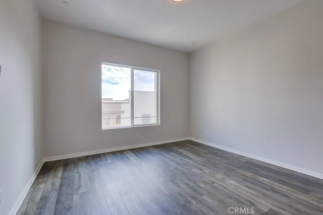a view of an empty room and wooden floor