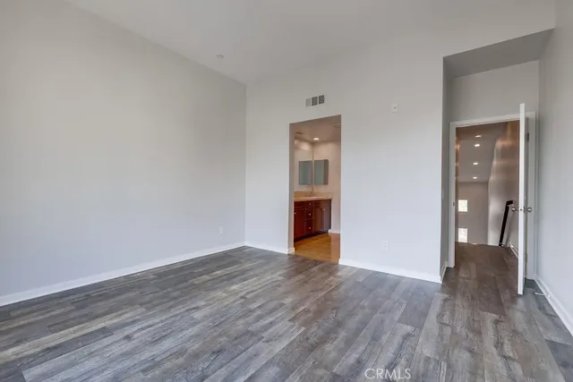 a view of an empty room and wooden floor