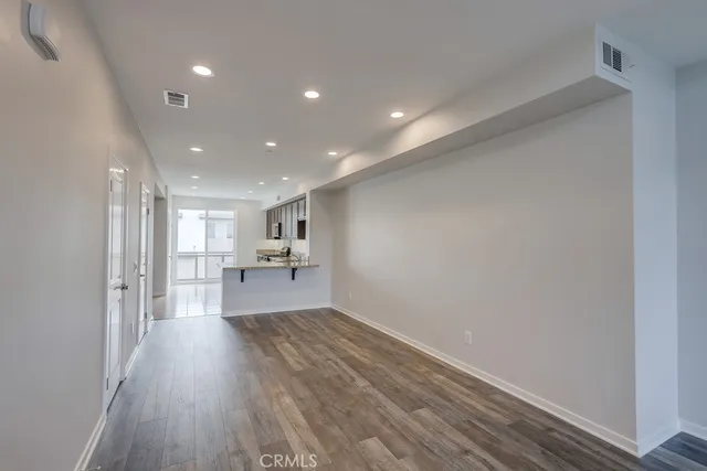 a view of a living room with wooden floor