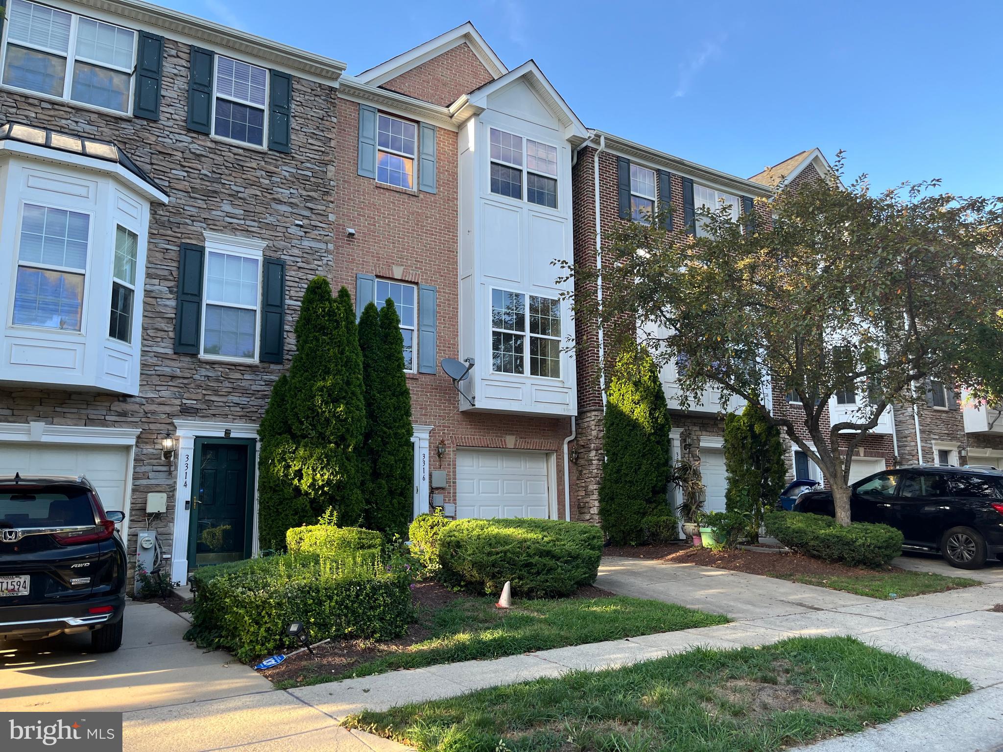 3316 Castle Ridge Circle, Unit 16 Silver Spring, MD 20904 - Photo 1 of 71 a front view of a house with yard and green space