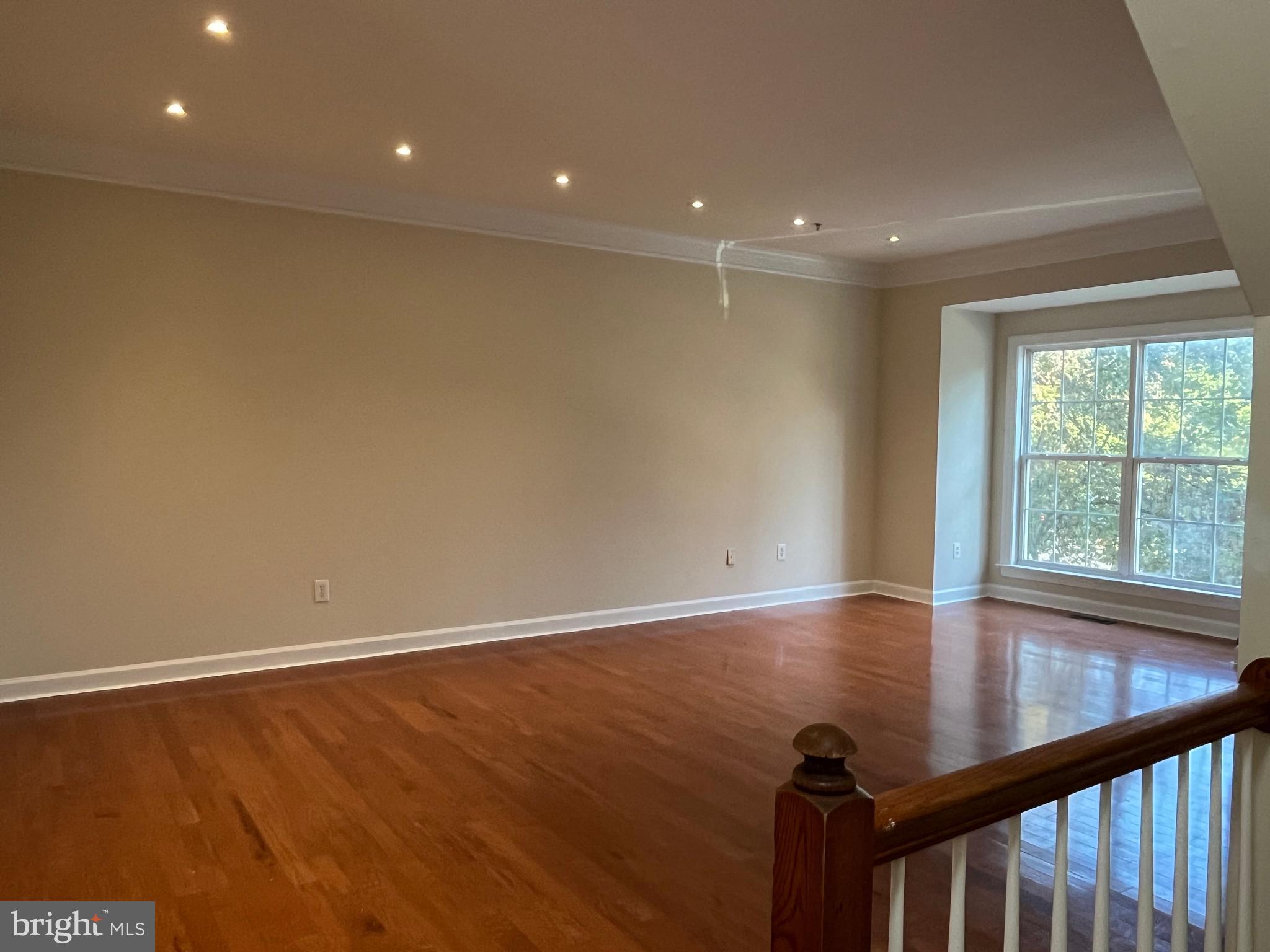 3316 Castle Ridge Circle, Unit 16 Silver Spring, MD 20904 - Photo 13 of 71 a view of an empty room with wooden floor and a window