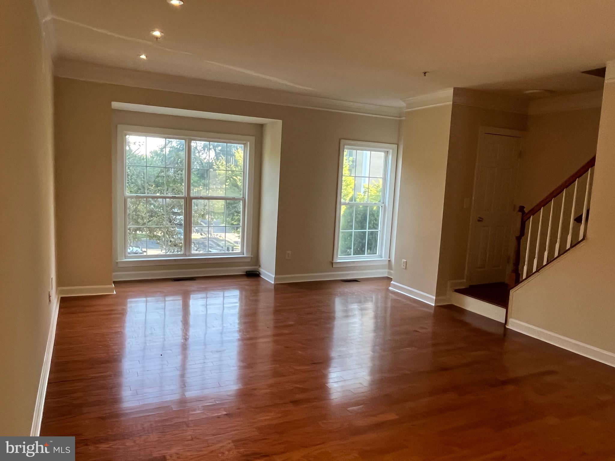 3316 Castle Ridge Circle, Unit 16 Silver Spring, MD 20904 - Photo 14 of 71 a view of an empty room with wooden floor and a window
