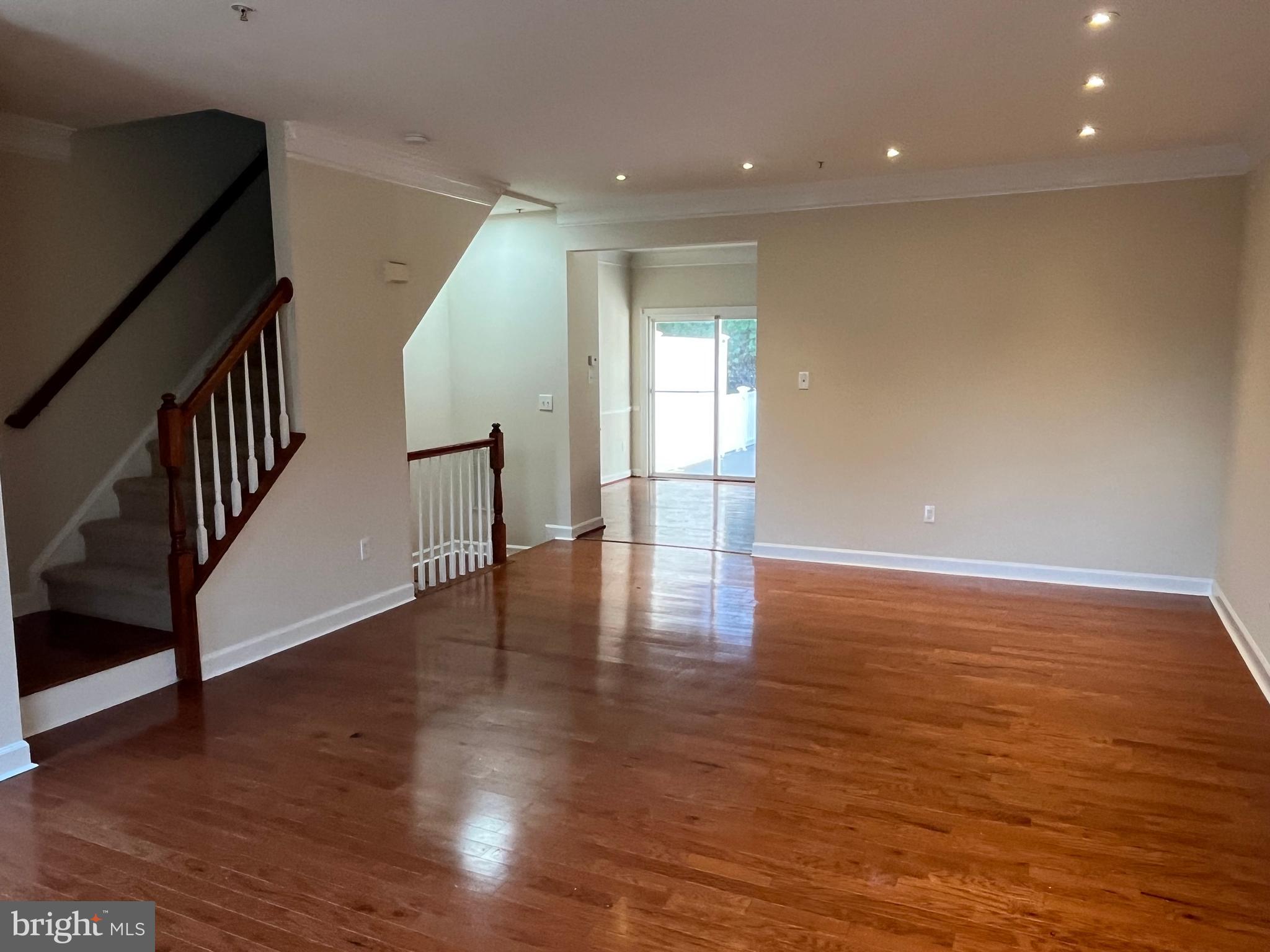 3316 Castle Ridge Circle, Unit 16 Silver Spring, MD 20904 - Photo 16 of 71 a view of an empty room with wooden floor and stairs
