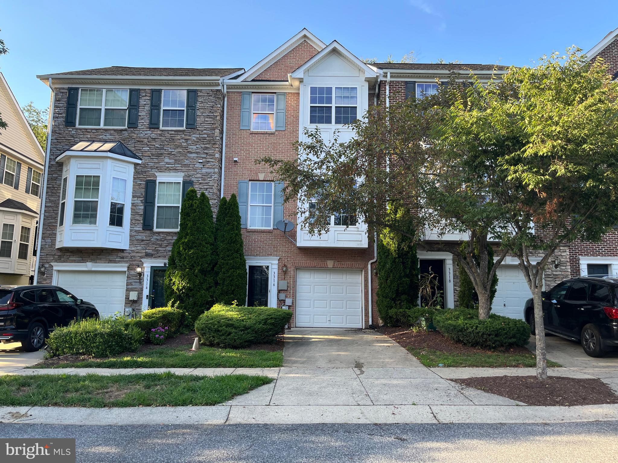 3316 Castle Ridge Circle, Unit 16 Silver Spring, MD 20904 - Photo 2 of 71 a front view of a house with a yard and garage