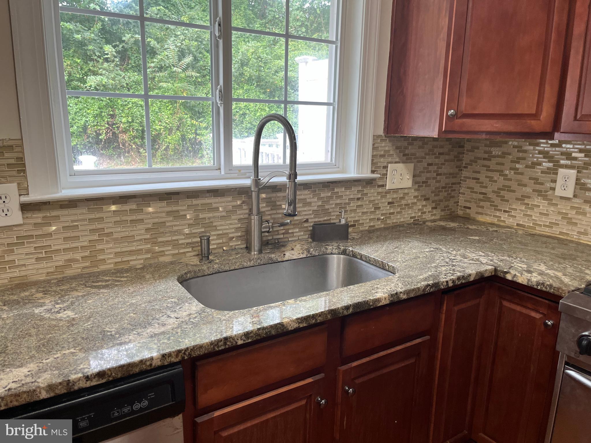 3316 Castle Ridge Circle, Unit 16 Silver Spring, MD 20904 - Photo 33 of 71 a kitchen with granite countertop a sink and a window