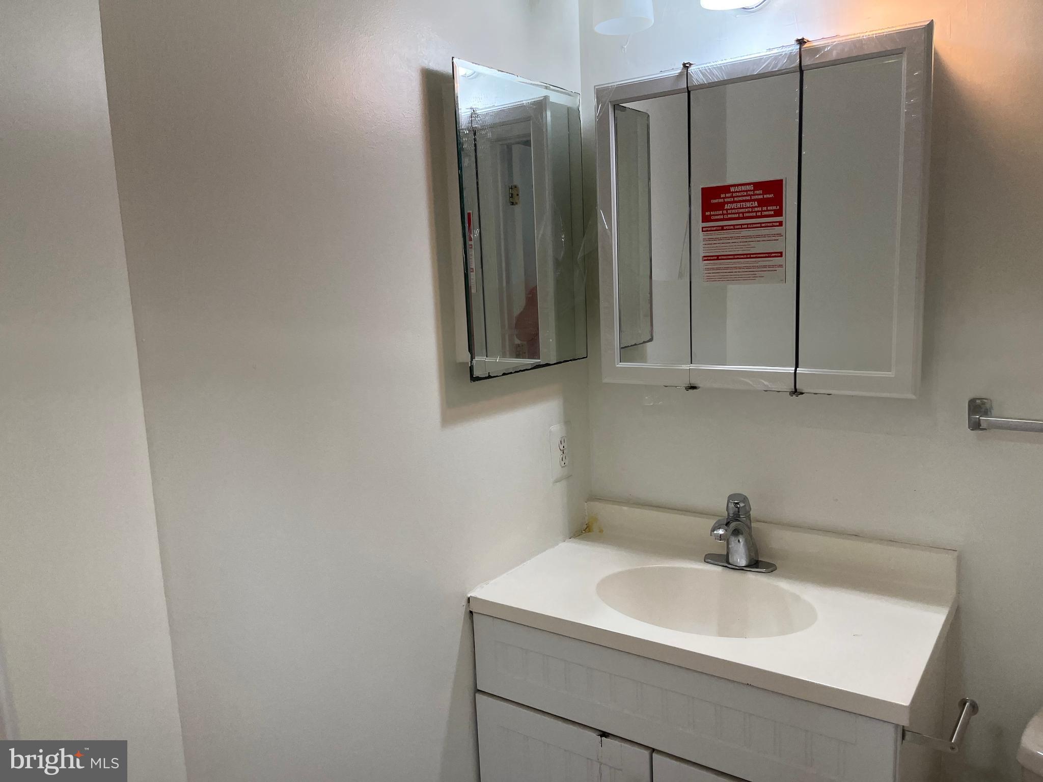 3316 Castle Ridge Circle, Unit 16 Silver Spring, MD 20904 - Photo 61 of 71 a bathroom with a sink and a mirror