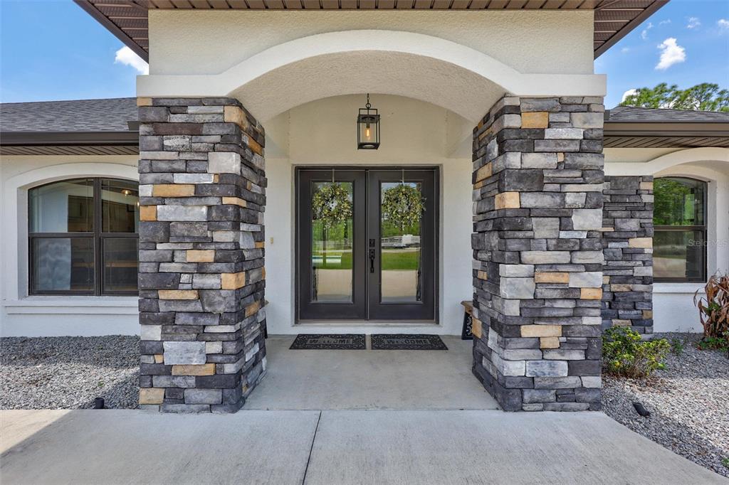 13362 Downy Woodpecker Road Weeki Wachee, FL 34614 - Photo 2 of 26 a front view of a house with a yard