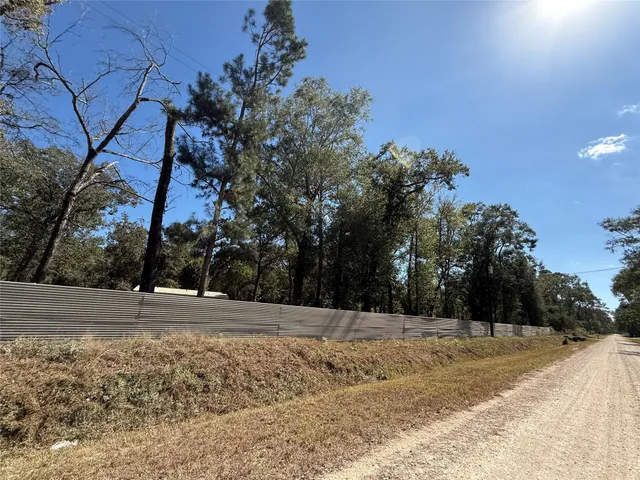 a view of yard covered with snow in front of house
