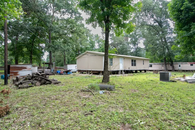a view of a house with backyard and sitting area