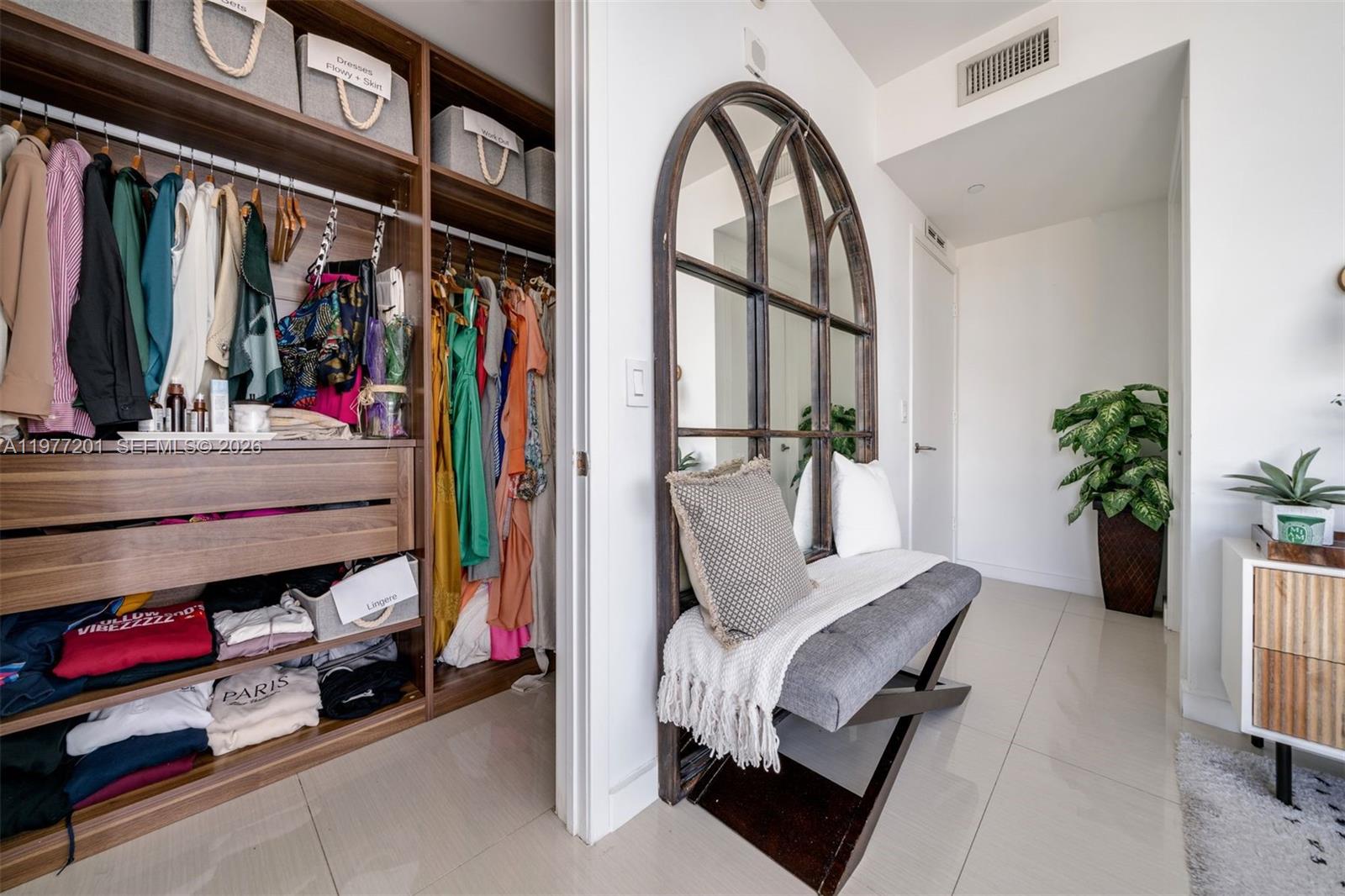 460 Northeast 28th Street, Unit 1901 Miami, FL 33137 - Photo 15 of 31 a view of walk in closet with clothes and shoes