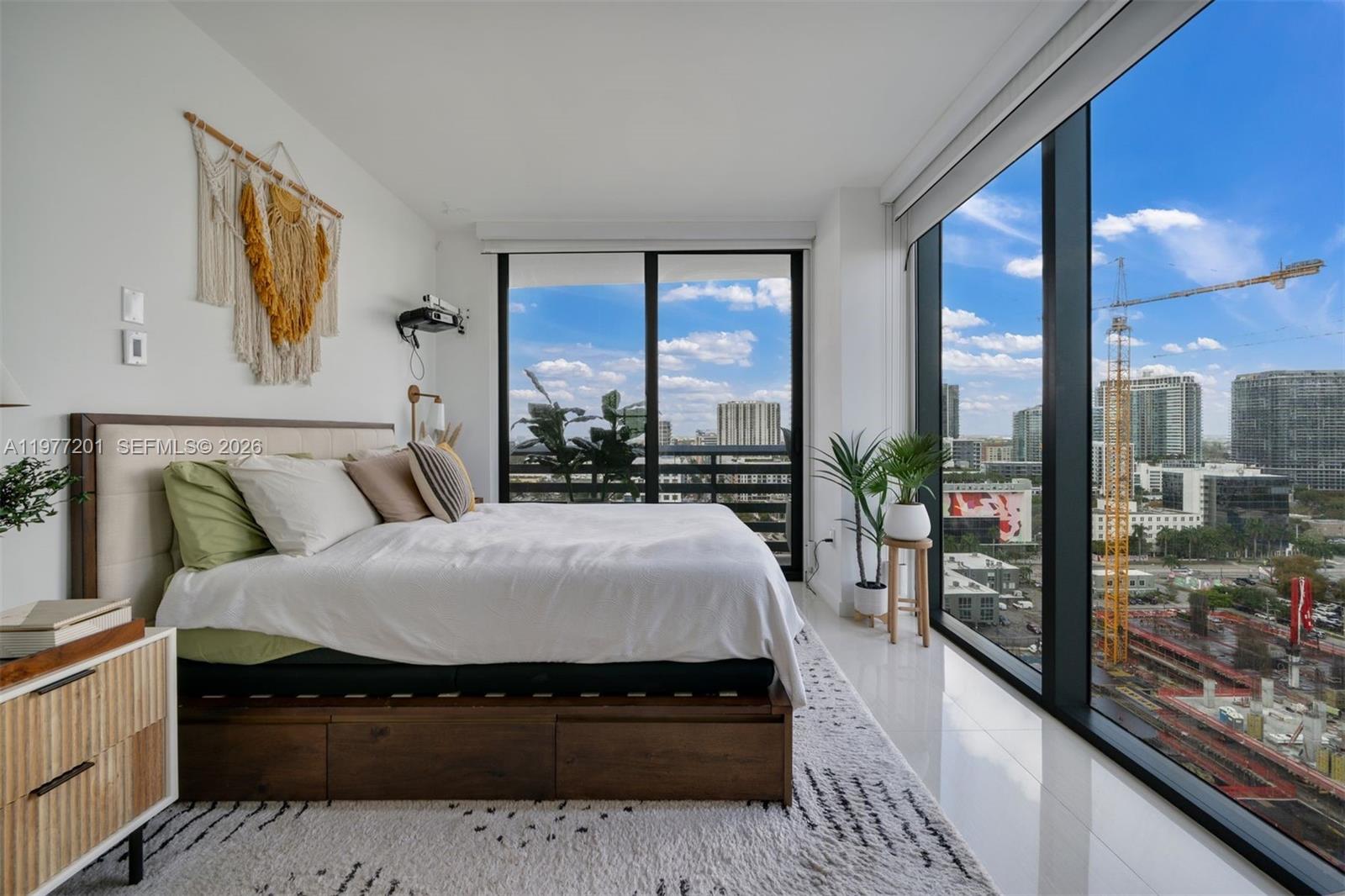 460 Northeast 28th Street, Unit 1901 Miami, FL 33137 - Photo 16 of 31 a large bedroom with a large bed and a large window
