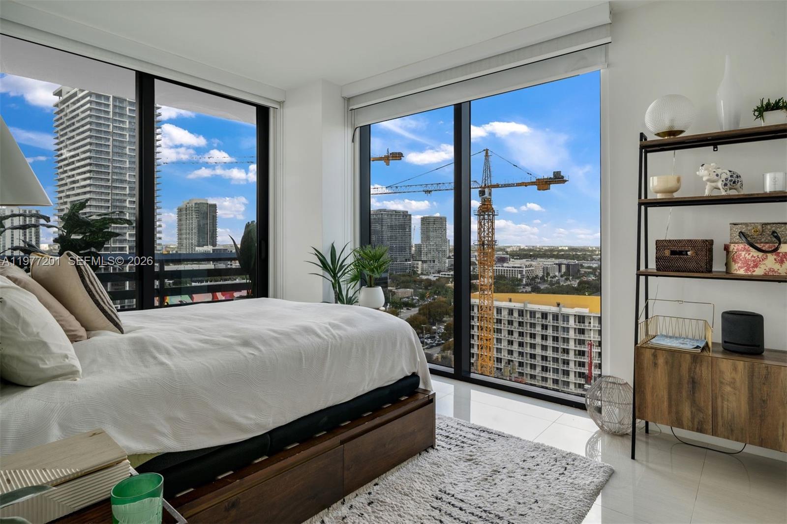 460 Northeast 28th Street, Unit 1901 Miami, FL 33137 - Photo 17 of 31 a bedroom with a bed and a chandelier