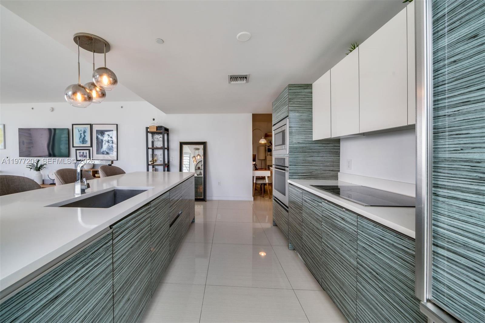 460 Northeast 28th Street, Unit 1901 Miami, FL 33137 - Photo 6 of 31 a large kitchen with a large counter space a sink and stainless steel appliances