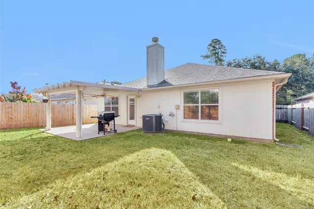 a view of a house with a yard and sitting area