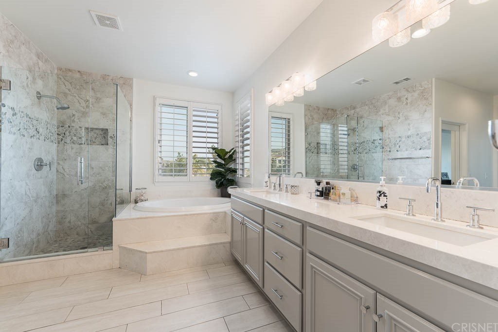 11564 Apulia Court Porter Ranch, CA 91326 - Photo 22 of 72 a bathroom with a double vanity sink toilet and shower
