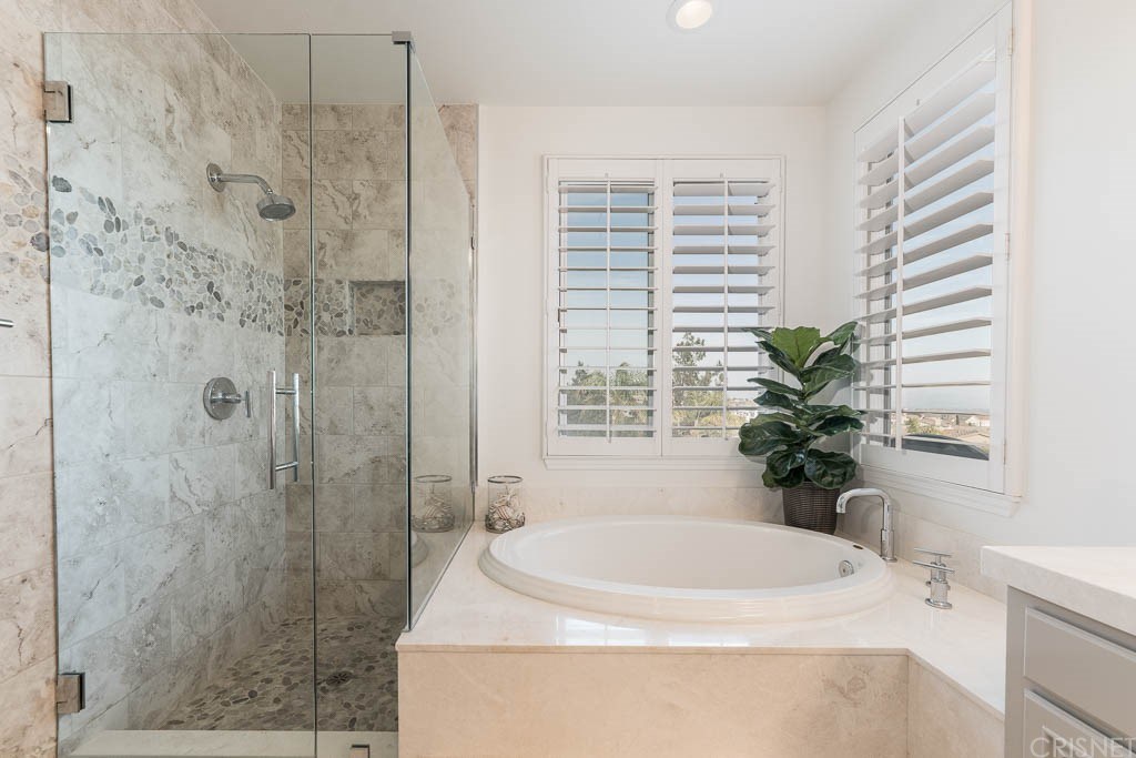 11564 Apulia Court Porter Ranch, CA 91326 - Photo 24 of 72 a bath tub sitting in a bathroom next to a sink