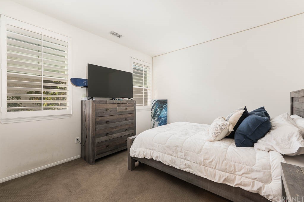 11564 Apulia Court Porter Ranch, CA 91326 - Photo 25 of 72 a bedroom with a bed and a flat screen tv
