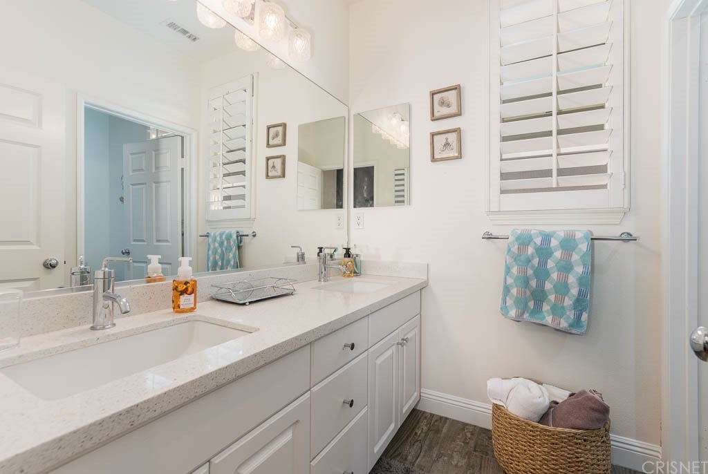 11564 Apulia Court Porter Ranch, CA 91326 - Photo 26 of 72 a bathroom with a sink double vanity and a mirror