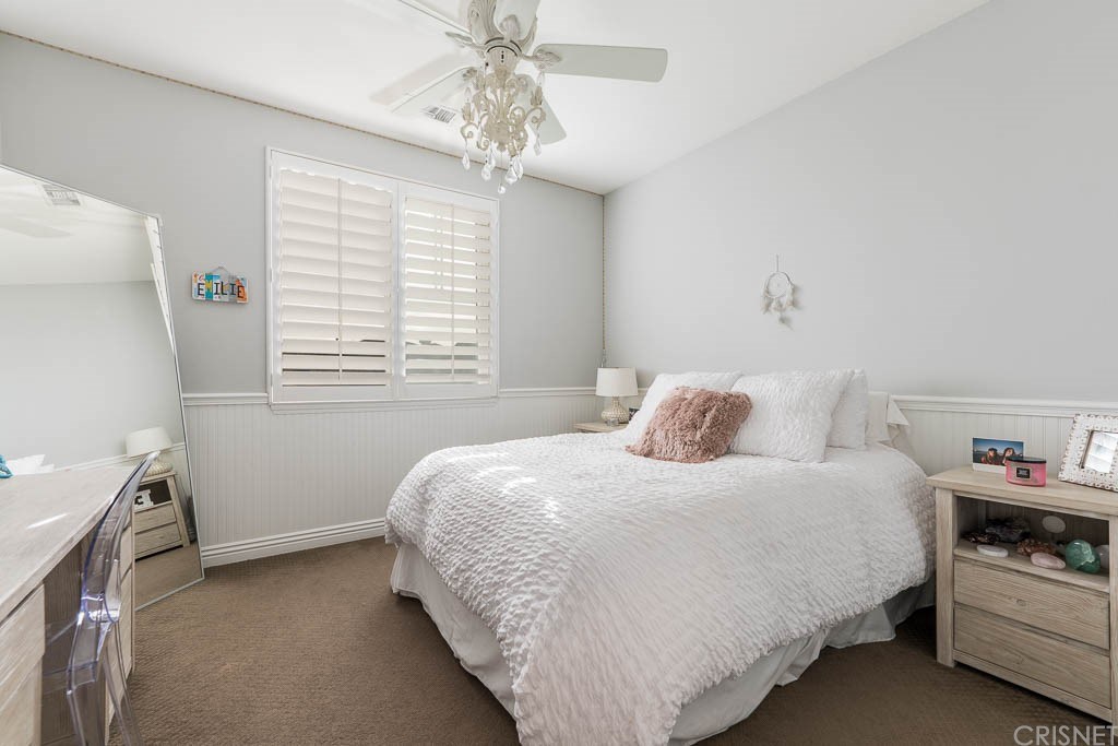 11564 Apulia Court Porter Ranch, CA 91326 - Photo 28 of 72 a bedroom with a bed and a chandelier