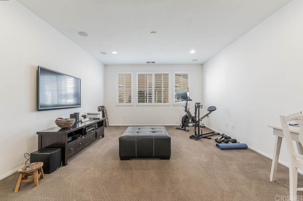 11564 Apulia Court Porter Ranch, CA 91326 - Photo 30 of 72 a living room with furniture window and a flat screen tv