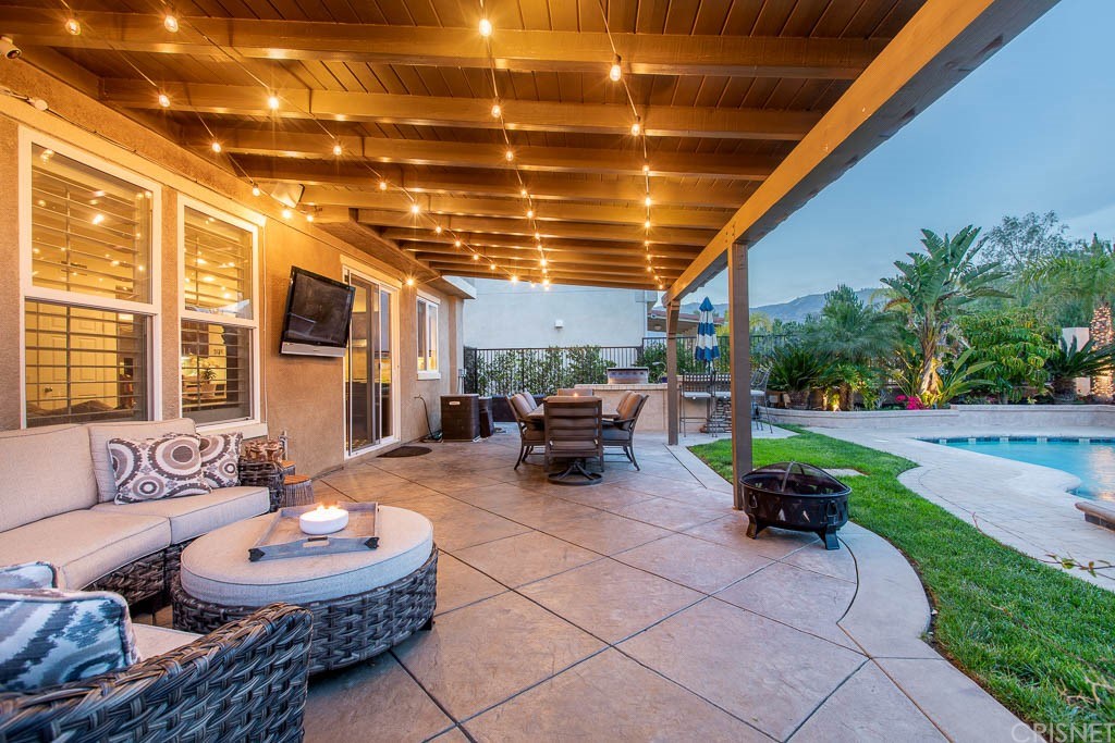 11564 Apulia Court Porter Ranch, CA 91326 - Photo 32 of 72 a living room with patio furniture and a large tree