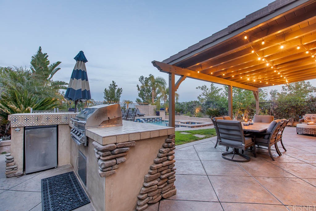 11564 Apulia Court Porter Ranch, CA 91326 - Photo 34 of 72 a view of a patio with table and chairs and potted plants
