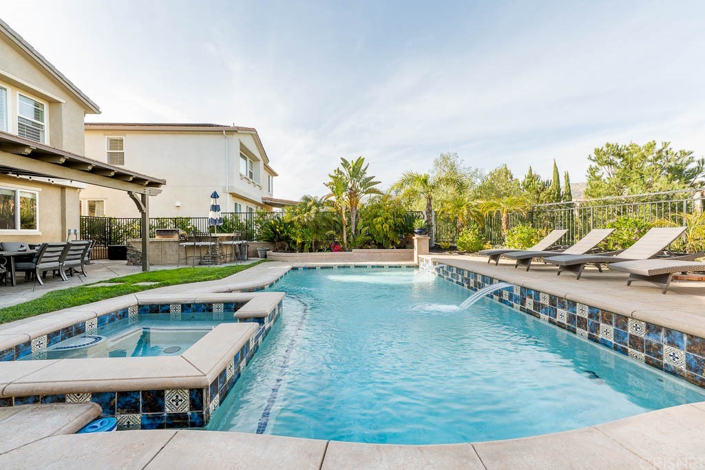 11564 Apulia Court Porter Ranch, CA 91326 - Photo 37 of 72 a view of a swimming pool with a lounge chair
