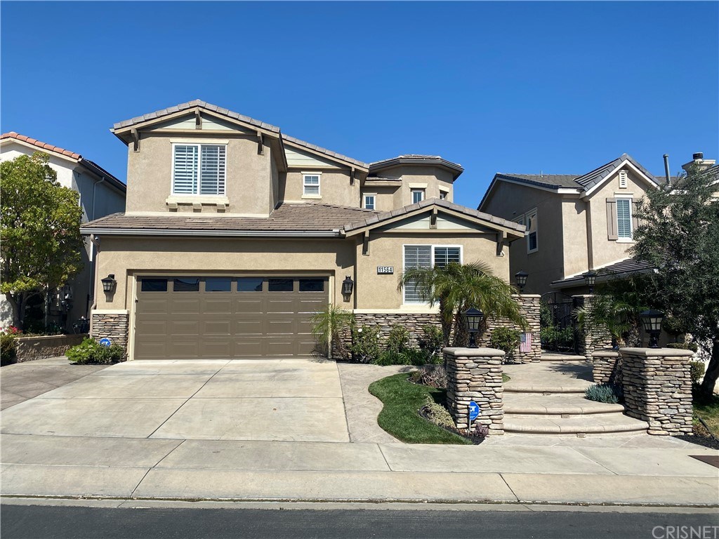 11564 Apulia Court Porter Ranch, CA 91326 - Photo 57 of 72 a front view of a house with a yard