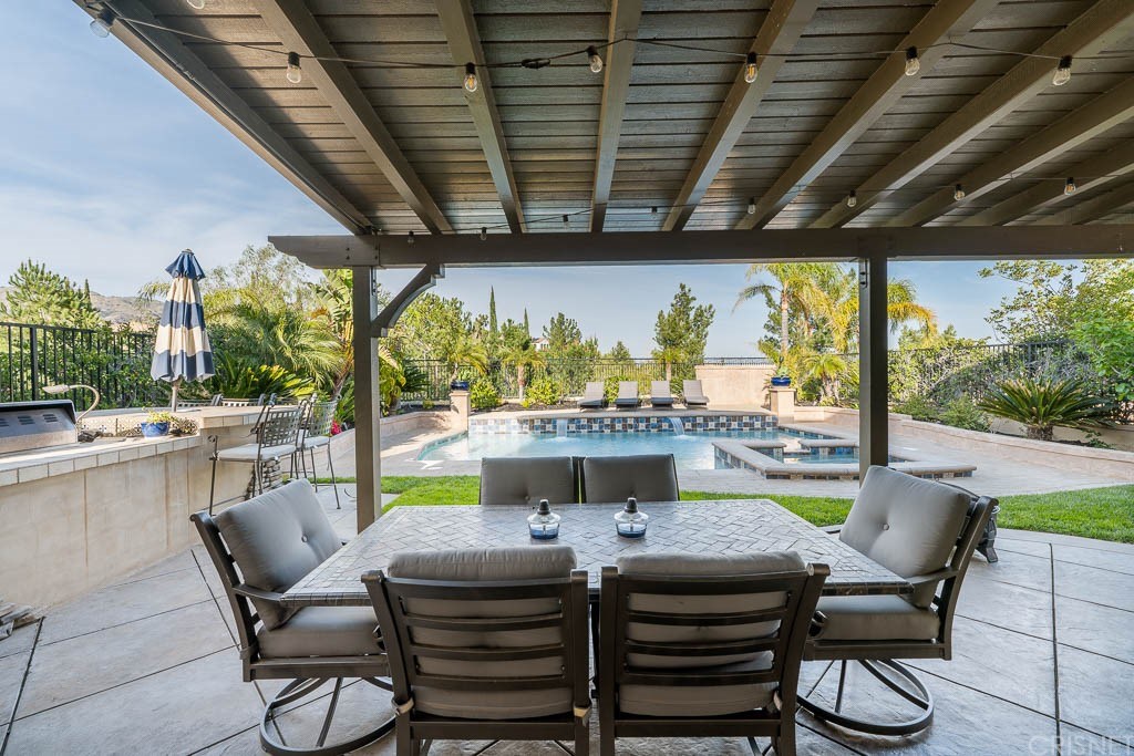 11564 Apulia Court Porter Ranch, CA 91326 - Photo 67 of 72 a view of a patio with a table chairs and a wooden floor
