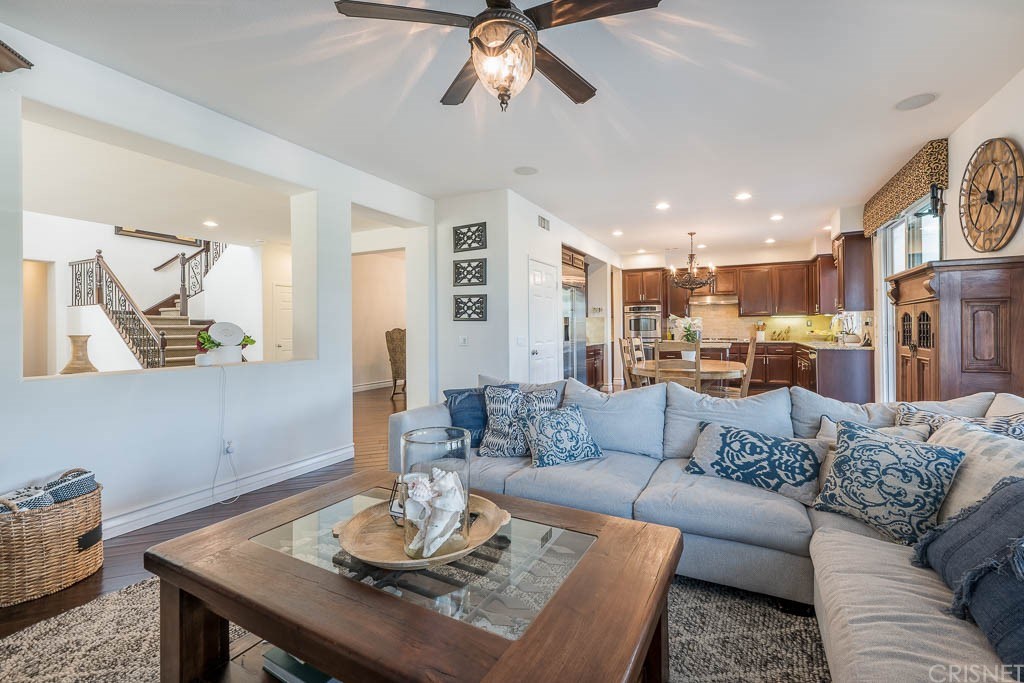 11564 Apulia Court Porter Ranch, CA 91326 - Photo 10 of 72 a living room with furniture kitchen view and a chandelier