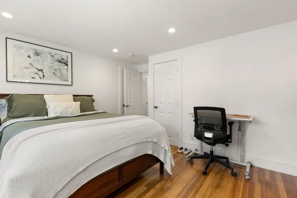 a bedroom with a bed and a desk