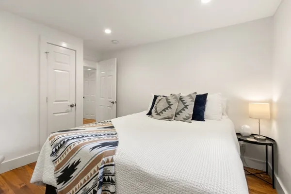 a bedroom with a bed and a mirror