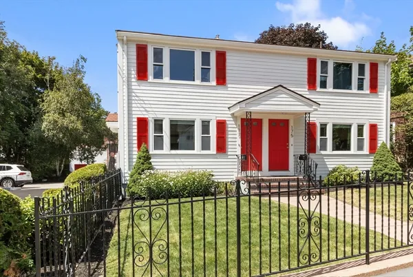 a front view of a house with a garden