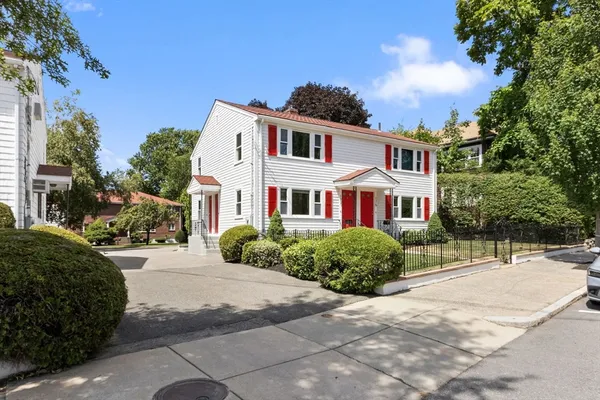 a front view of a house with a garden