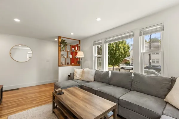 a living room with furniture and a large window