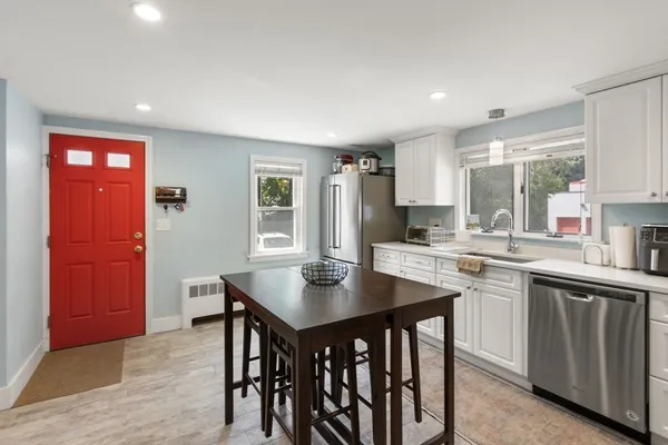 a kitchen with a table and chairs in it