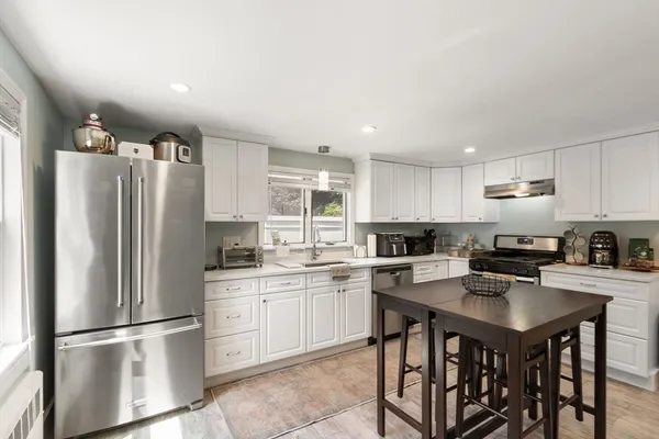 a kitchen with stainless steel appliances a refrigerator stove microwave and cabinets