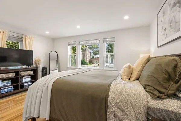 a bedroom with a bed and a flat screen tv