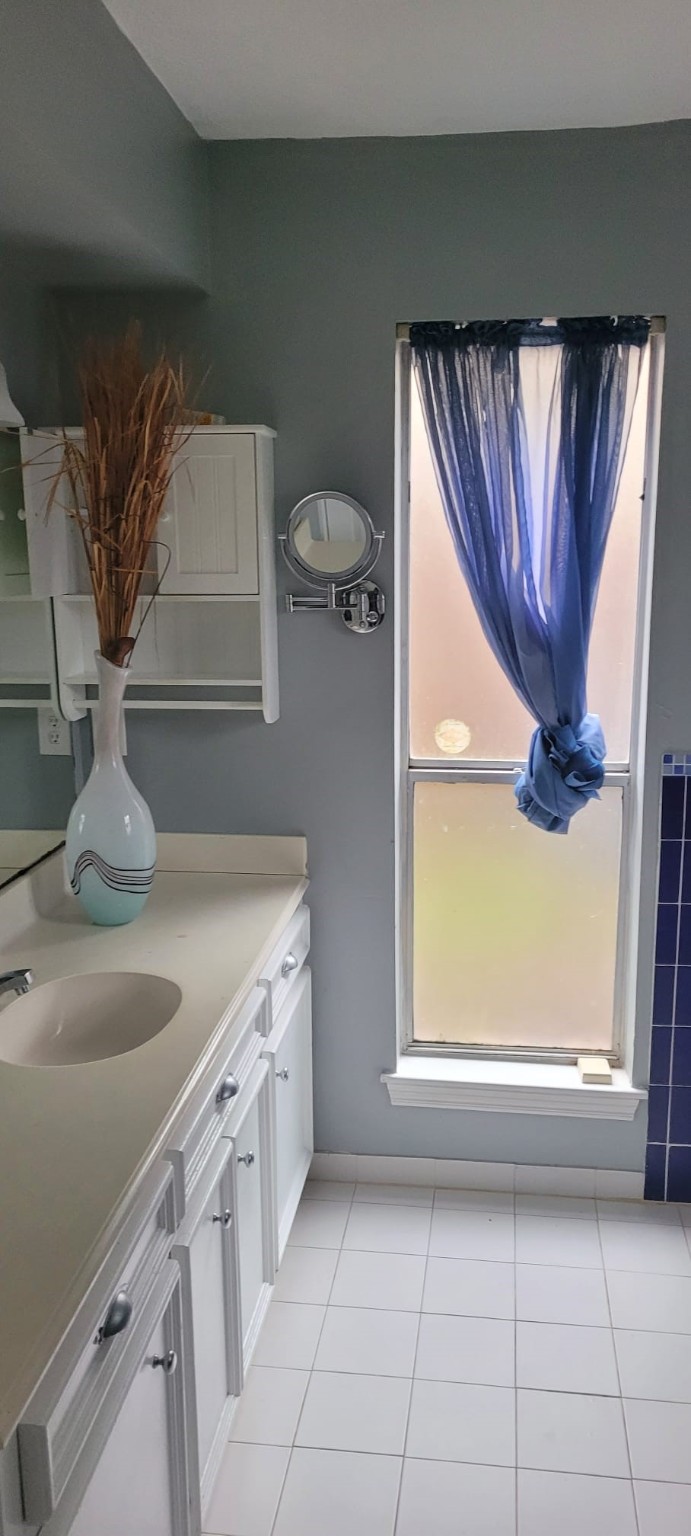 12007 Carriage Ridge Court Houston, TX 77070 - Photo 11 of 14 a kitchen with a sink a window and appliances