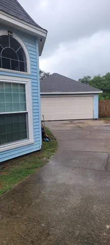 a view of a small barn with wooden fence